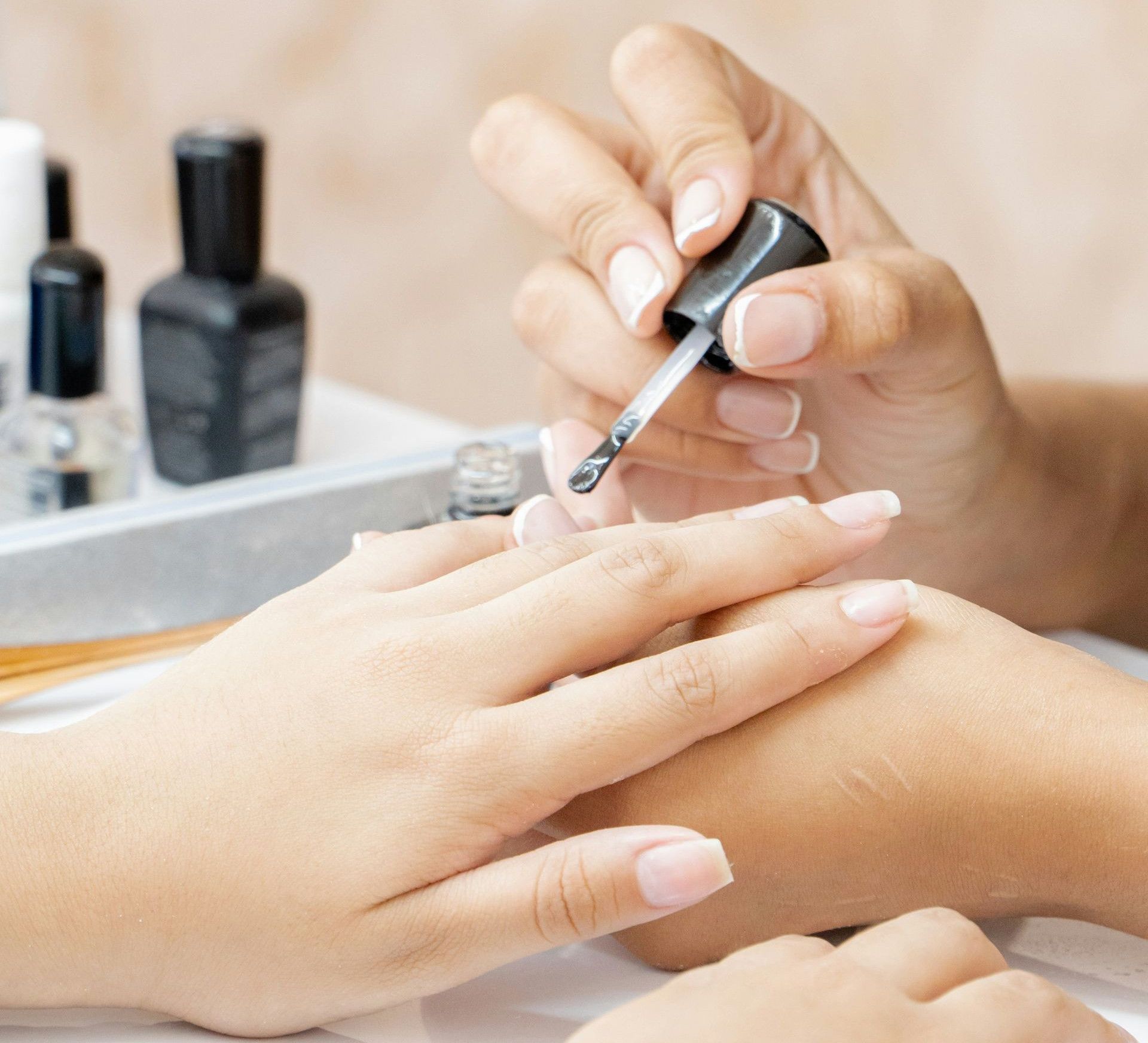 a woman is doing a manicure on a child's hand